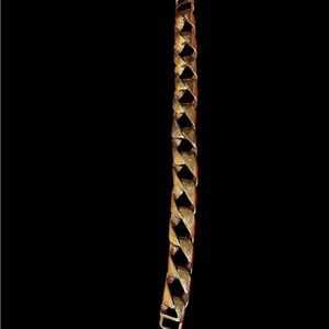 gold tone textured metal ribbon link bracelet.